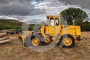 Excavator with grapple for transporting logs in a forestry operation