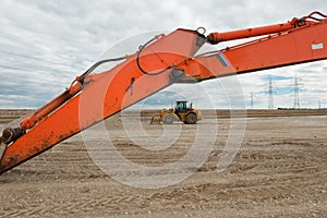 Excavator in a gravel pit with cloudy sky