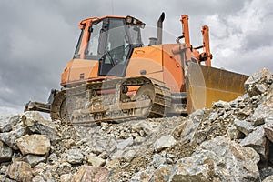 Excavator and heavy machinery for processing rock and stone in a quarry