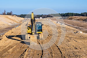 Excavator on a highway construction site.