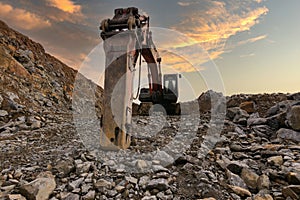 Excavator with hydraulic hammer on road construction works