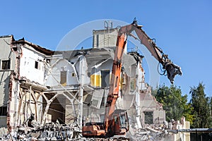 Excavator with hydraulic shears on construction site