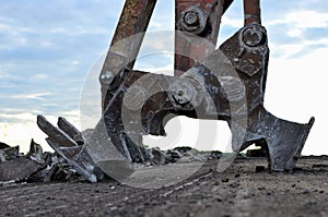 Excavator with hydraulic shears for cutting and crumbles demolition concrete and asphalt at construction site. Hydraulic breaker.