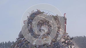 Excavator at landfill at winter, Russia