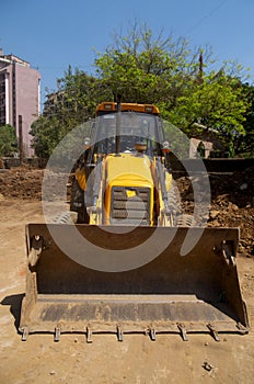 Excavator loader with backhoe front view