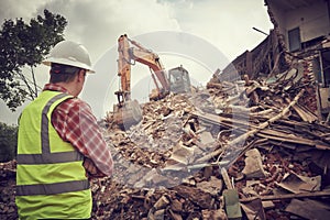 Excavator crasher machine at demolition on construction site