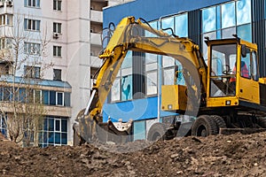 Excavator loader during earthworks at a construction site. The excavator is on the construction of a new park area.