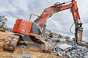 Excavator loader machine at demolition with hydrohammer on construction site