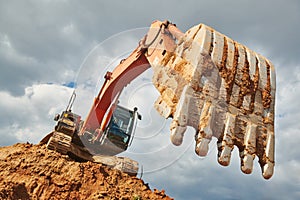 Excavator loader machine earthmoving soil at construction site