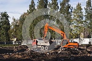 Excavator loading the dump truck photo