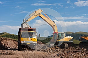 Excavator loading a dump truck
