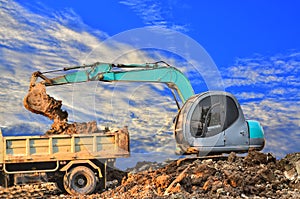 Excavator loading dumper truck tipper