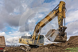 Excavator loading earth construction works