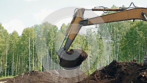 An excavator is loading the ground with a bucket