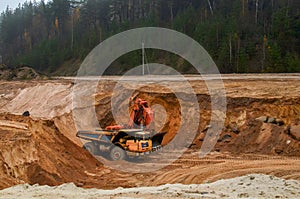 Excavator loading of sand, ore on the dump truck