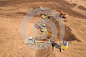 Excavator loading soil onto an Articulated hauler Truck