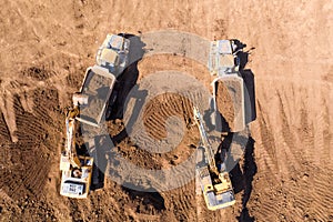 Excavator loading soil onto an Articulated hauler Truck