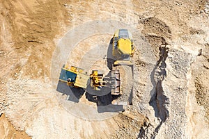 Excavator loading soil onto an Articulated hauler Truck