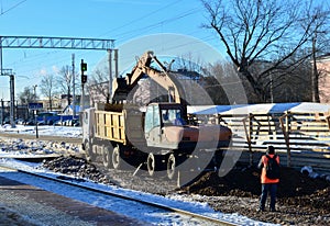 excavator loads crushed stone in a dump truck body. Construction of the railway. Preparing the surface of the earth for laying