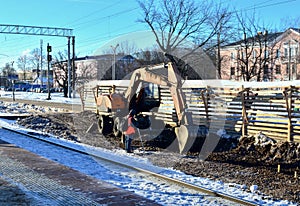 Excavator loads crushed stone in a dump truck body. Construction of the railway. Preparing the surface of the earth for laying