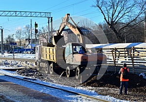 Excavator loads crushed stone in a dump truck body. Construction of the railway. Preparing the surface of the earth for laying