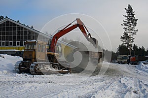 The excavator loads the crushed stone in the truck