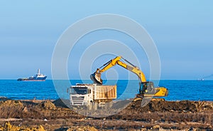 Excavator loads a dumper