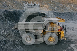 Excavator loads ore into a dump truck.