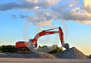 Excavator loads of stone and rubble for processing into cement or concrete for construction work and reuse. Backhoe at quarry.