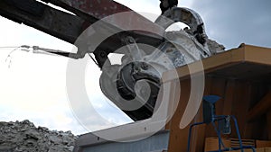 Excavator loads a truck rock in the quarry