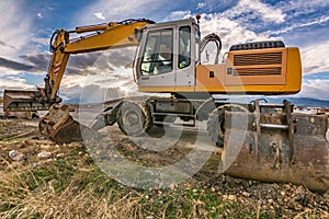 Excavator machine carrying out road maintenance works