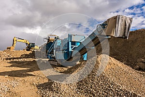 Excavator and machine to pulverize stone in a quarry photo