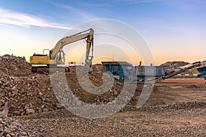 Excavator and machine to pulverize stone in a quarry photo