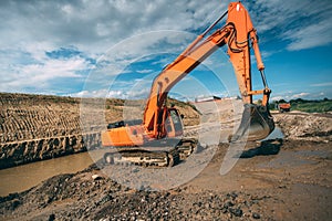 excavator machinery working in highway construction site. Building viaduct and digging with excavator