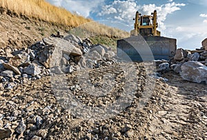 Excavator making a ditch in the construction of a road