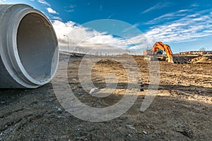 Excavator making a ditch to drive water through a pipe