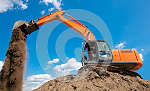 Excavator with metal tracks unloading soil at construction site