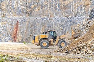Excavator mines stone in quarry