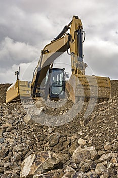 An excavator moves stone and rock in a quarry