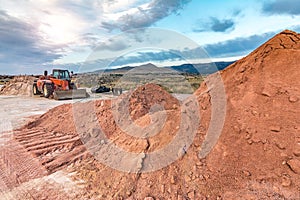 Excavator moving earth on construction works of a highway