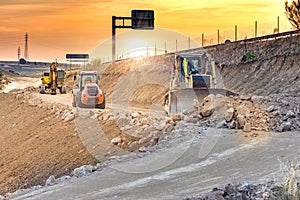 Excavator moving earth on construction works of a highway