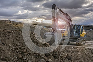 Excavator moving earth on a road construction works