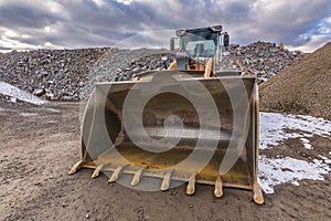 Excavator moving gravel and stone in a quarry