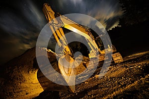 Excavator at night, dramatic lighting and composition