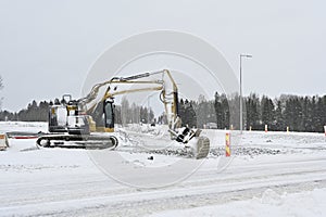 Excavator operating in snowy conditions