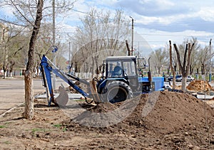 Excavator painted blue color side view digging