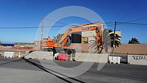 Excavator parked on the road side during the roadworks in El Medano, Tenerife