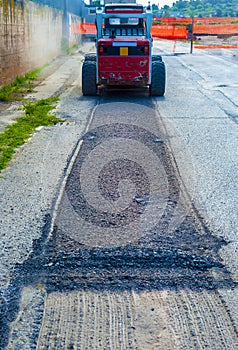 Excavator perform milling of asphalt