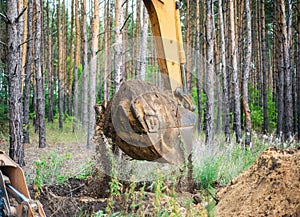 Excavator performs excavation work by digging the ground with a bucket