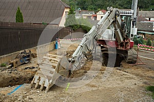 Excavator ploughshare on trench - constructing canalization